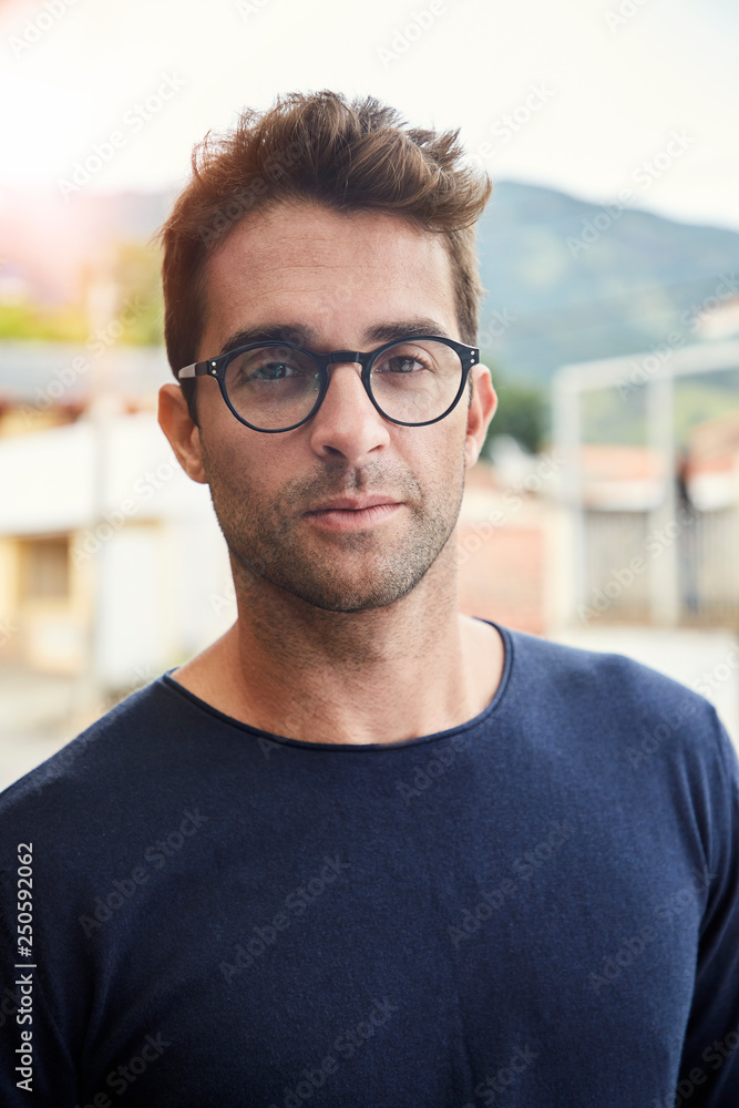 Good looking guy in glasses looking at camera Stock Foto Adobe Stock