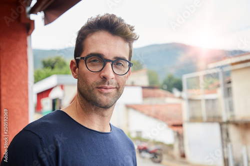Good looking dude in glasses, looking at camera