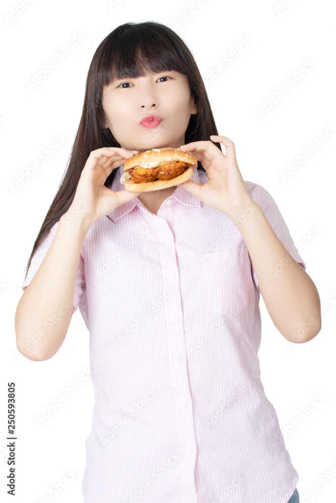 Chinese American woman eating Chicken Sandwich isolated on white background Chinese American woman eating Chicken Sandwich isolated on white background