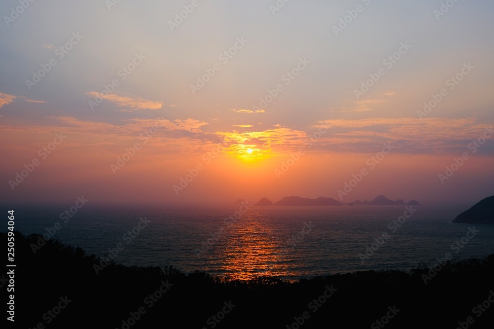 Beautiful sunrise image with colorful blue purple orange sky and white cloud with seascape landscape background