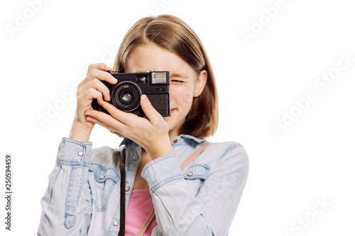 Teenager girl with a camera, close-up, isolated on white background