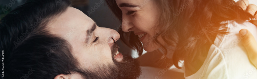 beautiful smiling couple looking at each other with sunlight beautiful smiling couple looking at each other with sunlight