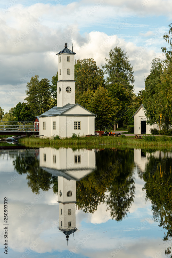 Obraz premium Old white watch tower building in summer evening sunlight