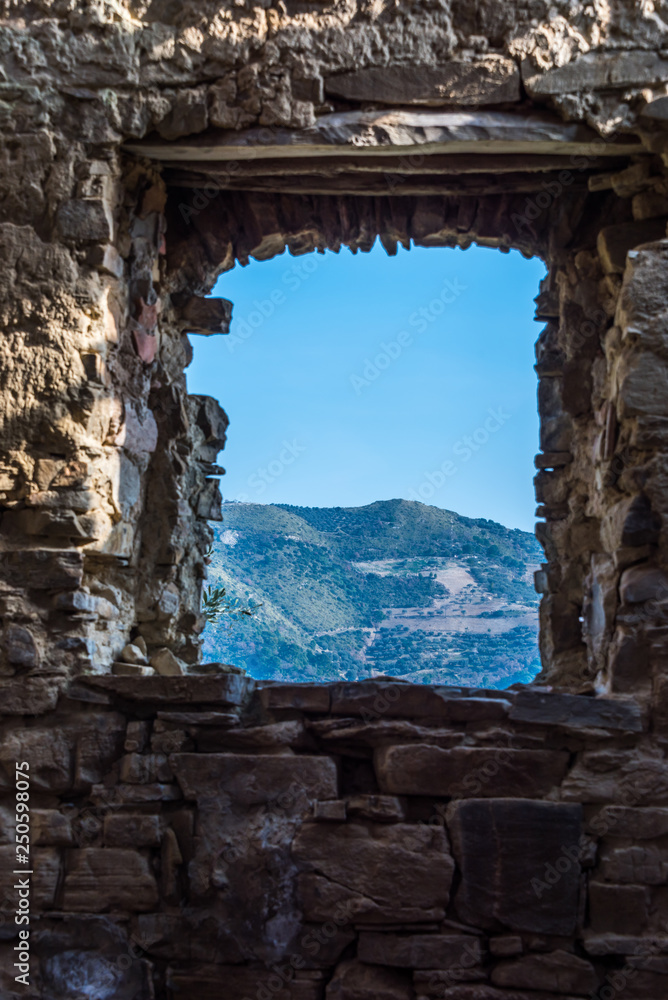 Window in an Ancient Windmill in the Hills of Southern Italy Window in an Ancient Windmill in the Hills of Southern Italy