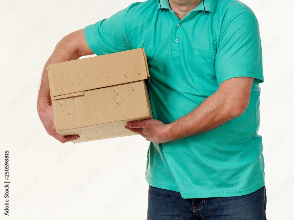 man holds in his hands a big box on a white background.