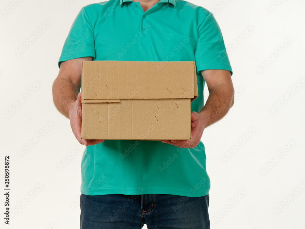 man holds in his hands a big box on a white background. man holds in his hands a big box on a white background.