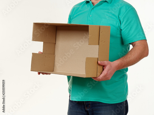 man holds in his hands a big box on a white background.