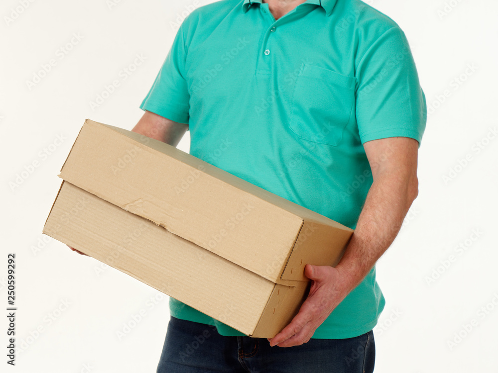 man holds in his hands a big box on a white background.