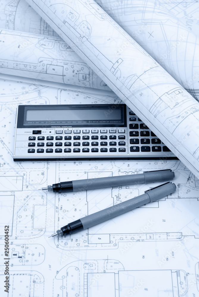 Architectural plans, calculator and drawing utensils Architectural plans, calculator and drawing utensils