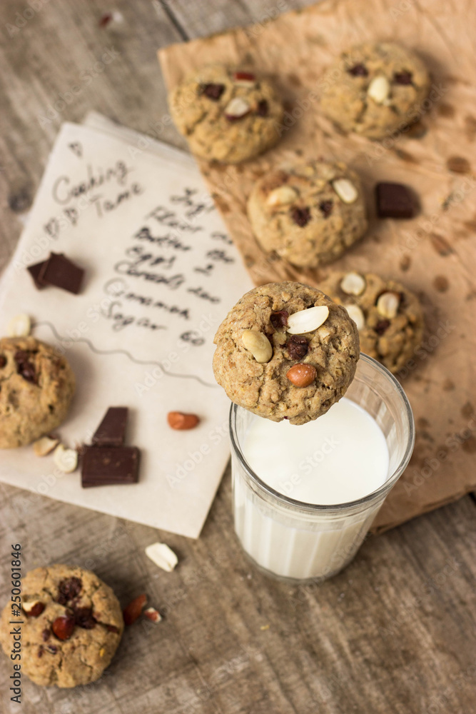 Homemade Oatmeal cookies with a glass of milk, photography in a rustic style, village and countryside wooden theme