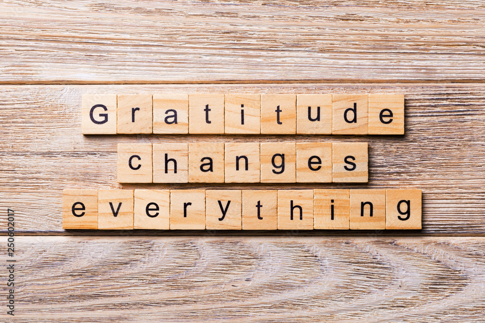 Gratitude changes everything word written on wood block. Gratitude changes everything text on wooden table for your desing, concept