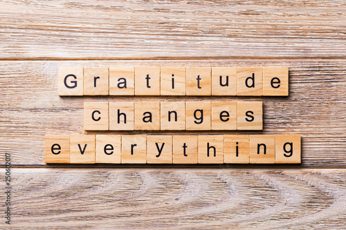 Gratitude changes everything word written on wood block. Gratitude changes everything text on wooden table for your desing, concept photo