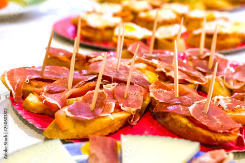Typical spanish tapas, serrano iberian ham over a slice of bread photo