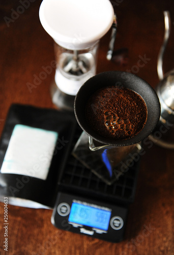 Coffee blooming in porous ceramic paperless filter. Alternative brewing. Gooseneck, electronic scales, manual grinder photo