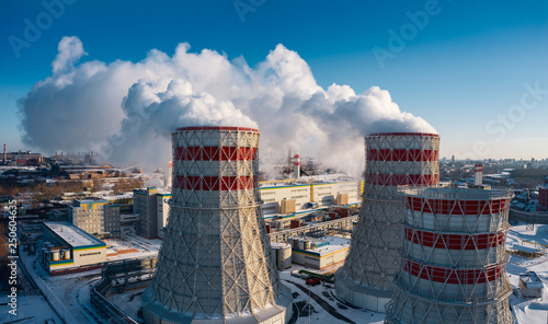 Concept of environmental pollution, drone view of smokestack pipe steel plant, aerial industrial panoramic landscape with blue sky in winter evening, air emissions from manufacturing sector,Russia