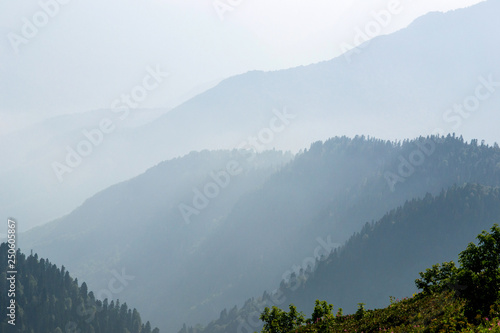 the majestic Caucasus mountains in the tonal perspective, and in the rays of the July sun and the outgoing