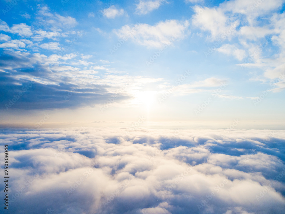 Aerial view White clouds in blue sky. Top view. View from drone. Aerial  bird's eye view. Aerial top view cloudscape. Texture of clouds. View from  above. Sunrise or sunset over clouds Stock