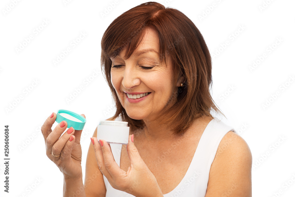beauty, skincare and cosmetics concept - smiling senior woman with cream jar beauty, skincare and cosmetics concept - smiling senior woman with cream jar