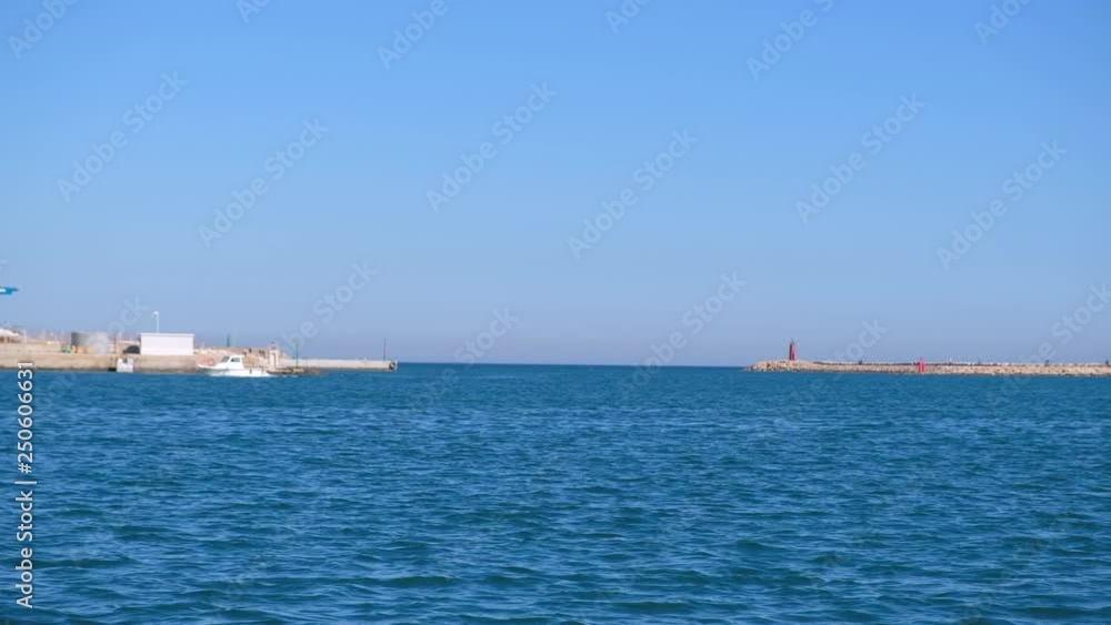 White motor yacht floating along the seaside White motor yacht floating along the seaside