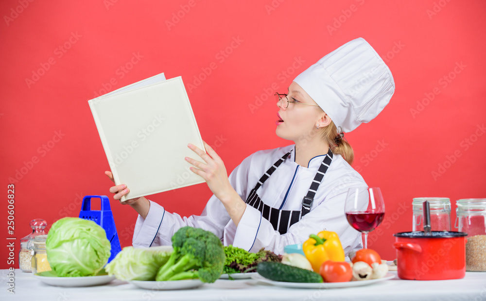 Culinary expert. Woman chef cooking healthy food. Girl read book top best culinary recipes. Culinary school concept. Female in hat and apron knows everything about culinary arts. Traditional cuisine Culinary expert. Woman chef cooking healthy food. Girl read book top best culinary recipes. Culinary school concept. Female in hat and apron knows everything about culinary arts. Traditional cuisine