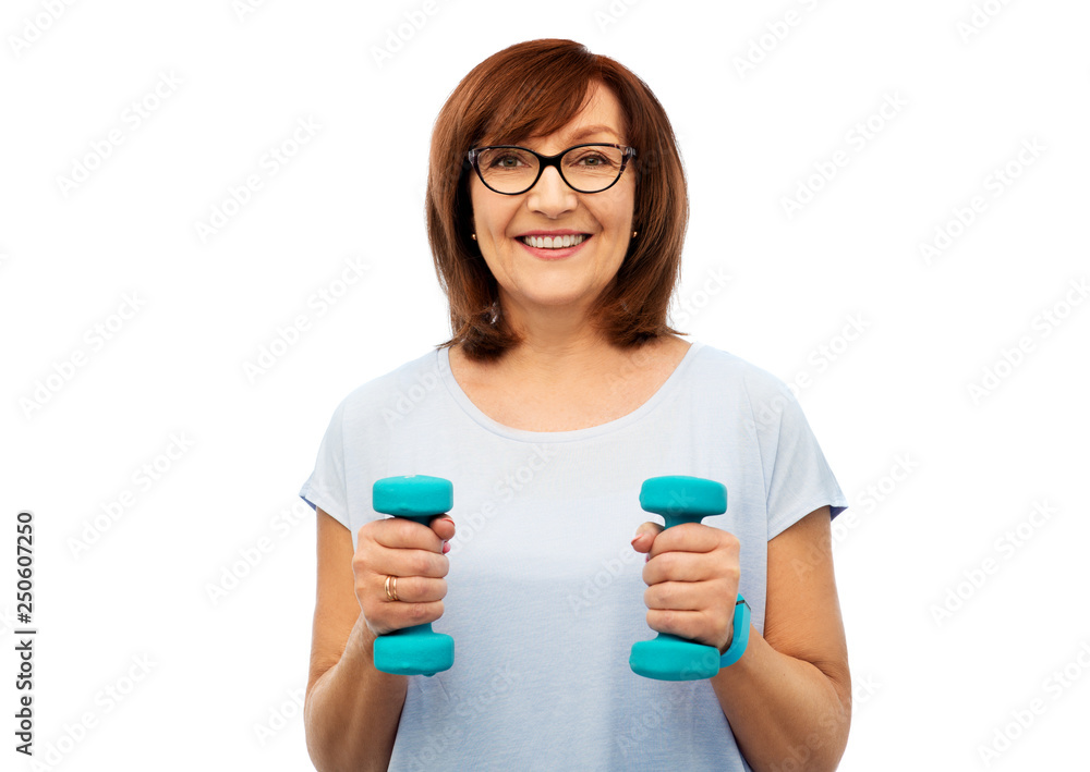 sport and old people concept - smiling senior woman with dumbbells and fitness tracker exercising over white background sport and old people concept - smiling senior woman with dumbbells and fitness tracker exercising over white background