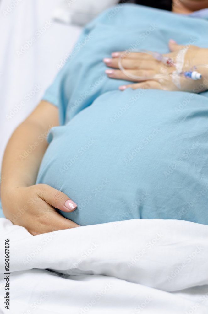 A pregnant woman lying in a hospital bed waiting for her cesarean A pregnant woman lying in a hospital bed waiting for her cesarean
