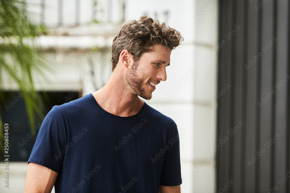 Happy bearded guy in blue t-shirt, looking away Happy bearded guy in blue t-shirt, looking away
