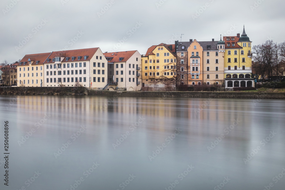 Regensburg, Germany - January 2019: Architecture of Old Town of Regensburg city on the rive Danube. Long exposure.