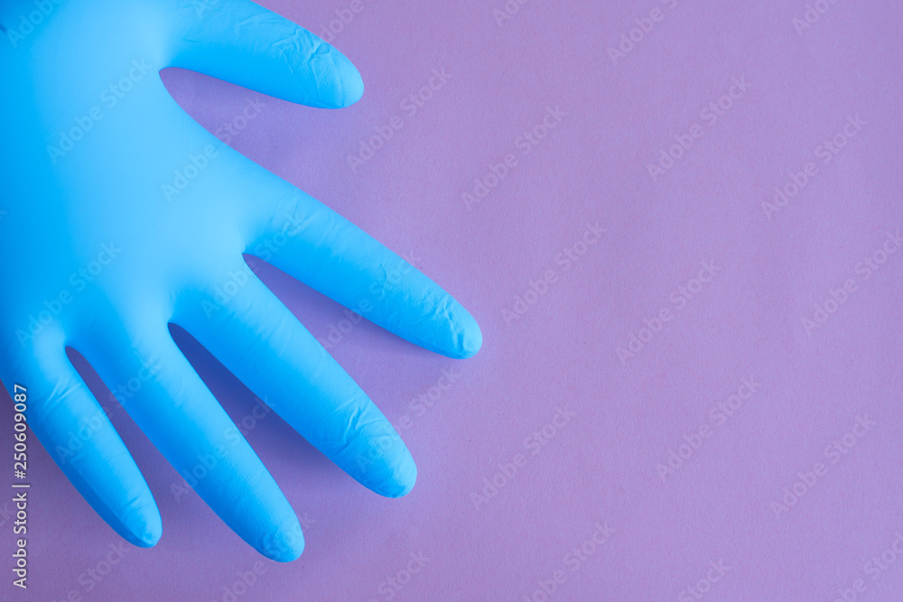 blue rubber gloves on pink background. overalls and uniforms. hand protection blue rubber gloves on pink background. overalls and uniforms. hand protection
