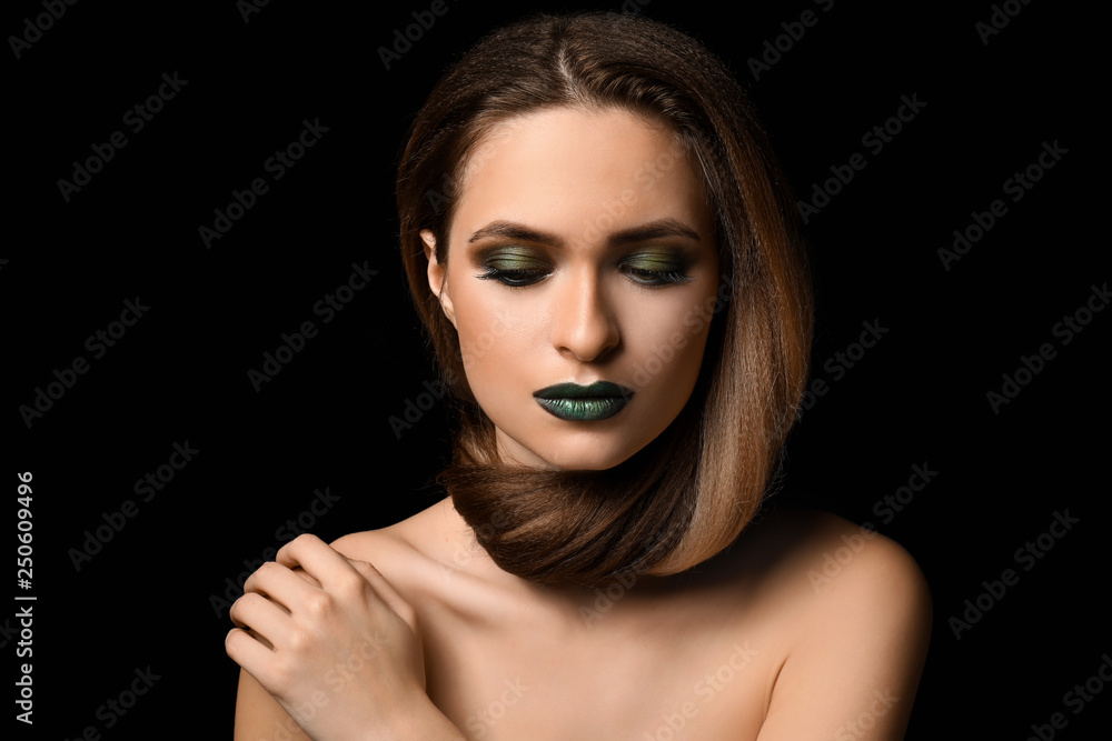 Beautiful young woman with bright makeup on dark background Beautiful young woman with bright makeup on dark background