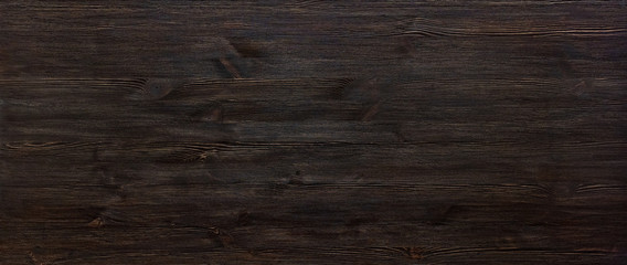 Dark brown painted wooden desk background tabletop wide horizontal photo banner for website design, black blank rustic wood texture timber board surface empty table header with copy space, top view