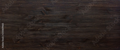 Obraz na plátně Dark brown painted wooden desk background tabletop wide horizontal photo banner