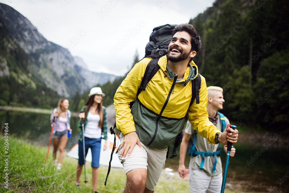 Fotografia do Stock: Group of young friends hiking in countryside