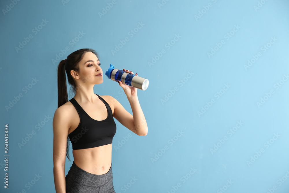 Sporty young woman with bottle of water on color background Sporty young woman with bottle of water on color background