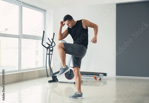 Sporty young man training in gym