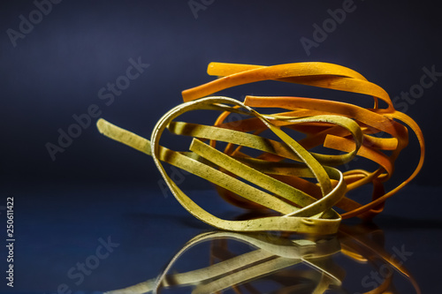 Colored pasta lay on glass