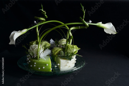 Flower arrangement with arums in a black background photo