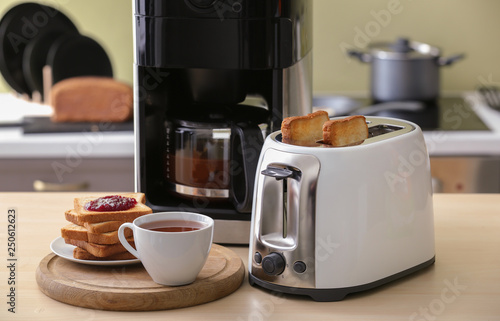 Obraz na plátne Toaster with bread slices and coffee machine on table