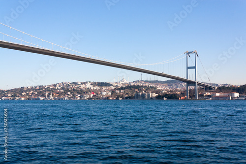 A tourist ship sails through the Bosphorus. Istanbul, Turkey. View of the city. Tourism and travel. © AlesiaKan