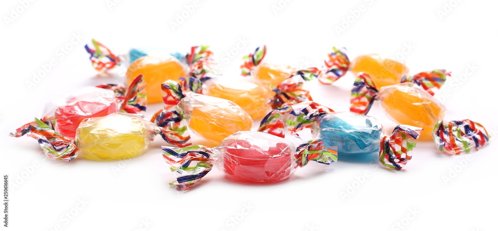 Colorful hard candies in transparent cellophane wrapping, isolated on white background