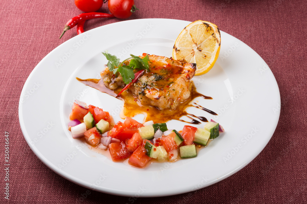 Grilled white fish fillet with vegetable salad