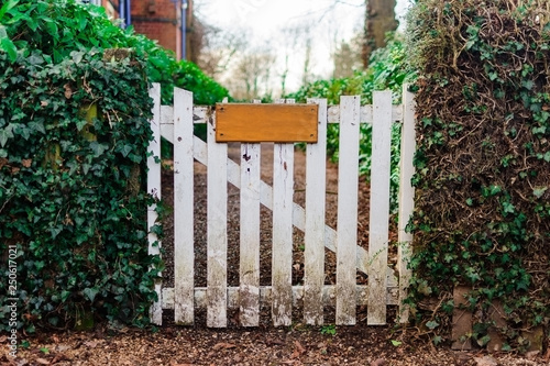 Wooden gate to garden with wooden sign