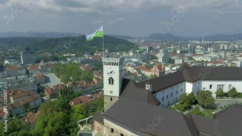 Ancient and oustanding part of the castle in the centre of Ljubljana, Slovenia. The tower boasts about famous flag with iconic green dragon. photo
