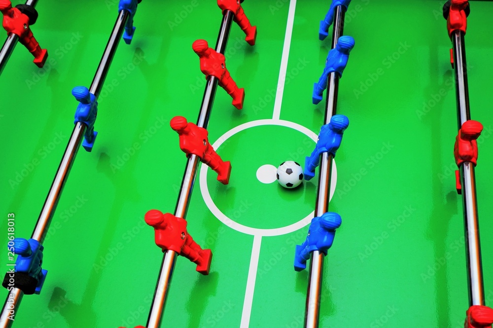 Table football with red and blue players Table football with red and blue players
