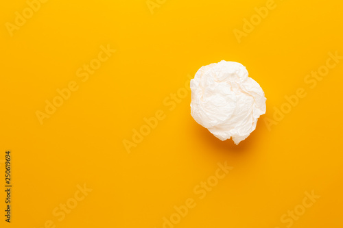White paper bag on yellow background.