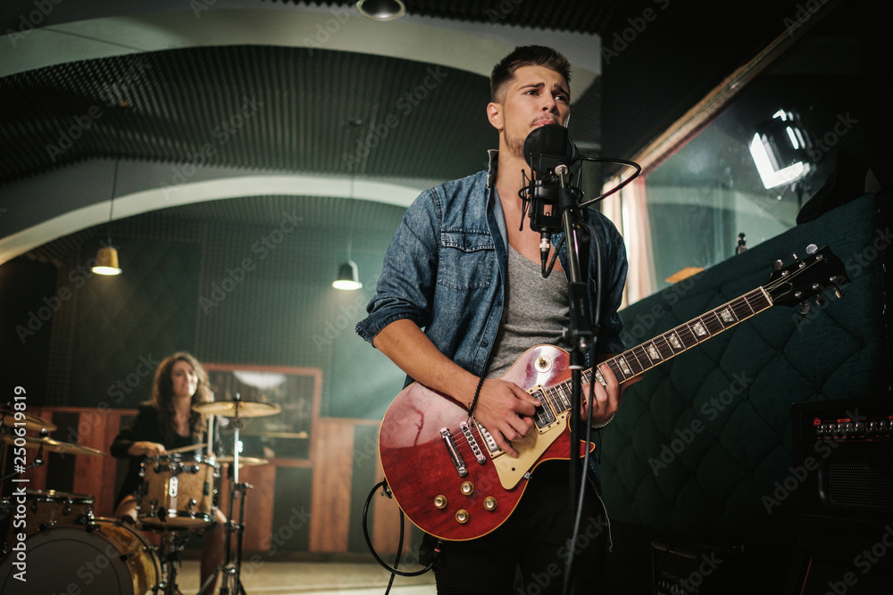 Fototapeta premium Music band having rehearsal in a studio