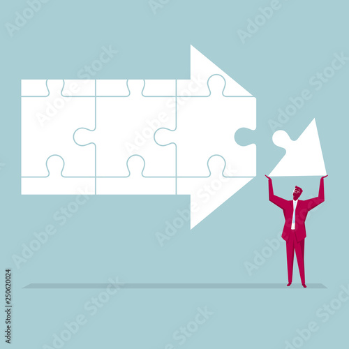 A businessman is combining an arrow symbol. Jigsaw puzzle.