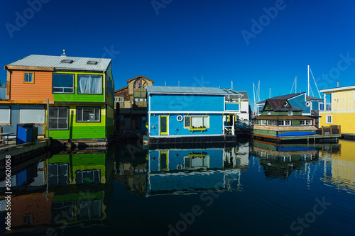 Floating Home Village Houseboats Fisherman's Wharf Inner Harbor, Victoria British Columbia Canada.Area has floating homes, boats, piers, restaurants and adventure tours