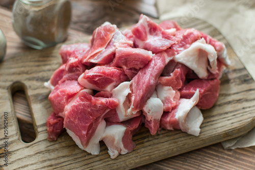 Fresh raw pork sliced on wooden background.