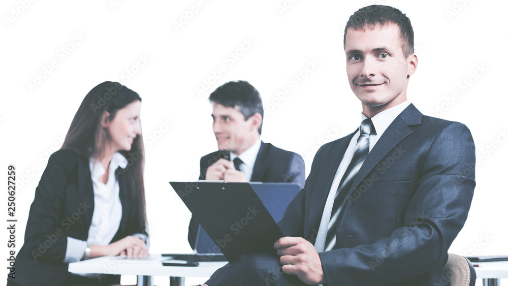 Portrait of a young businessman on background working team Portrait of a young businessman on background working team